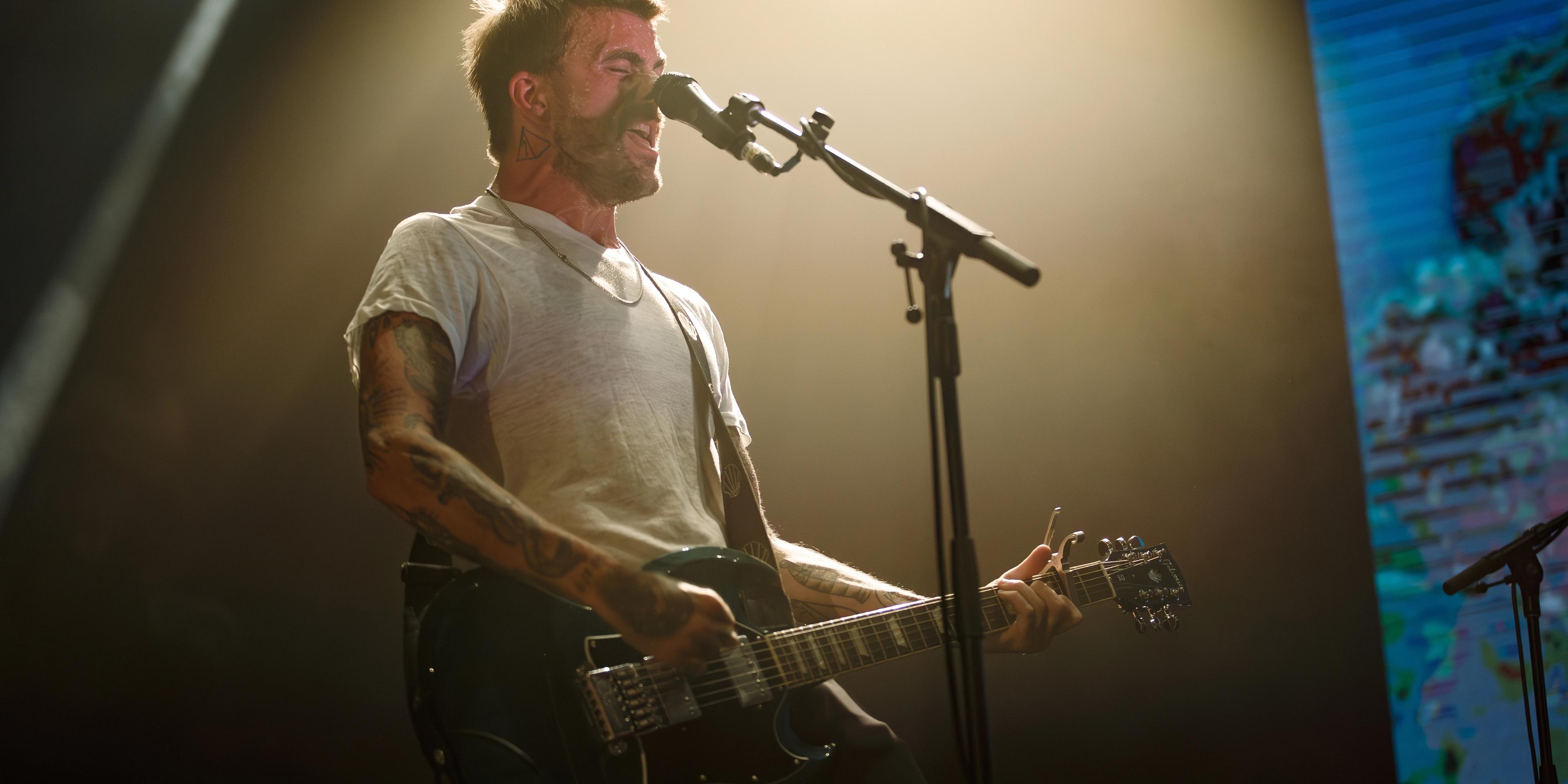 Anthony Green performing live on stage during a solo set