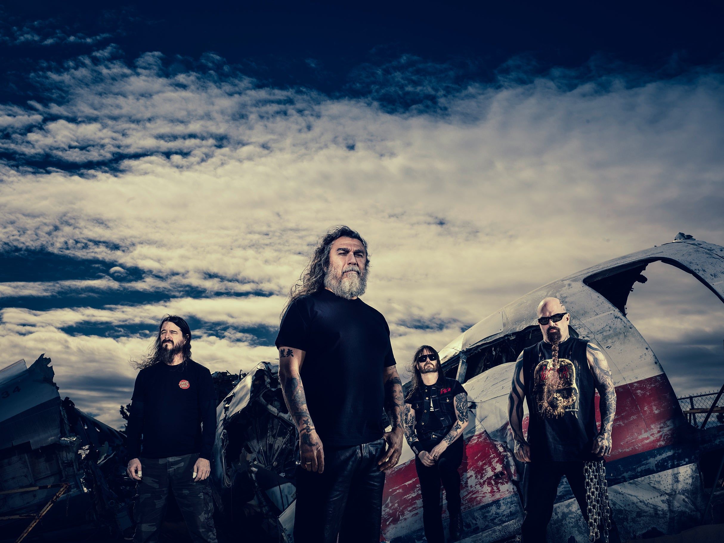 Slayer performing live on stage with dramatic lighting during their reunion era