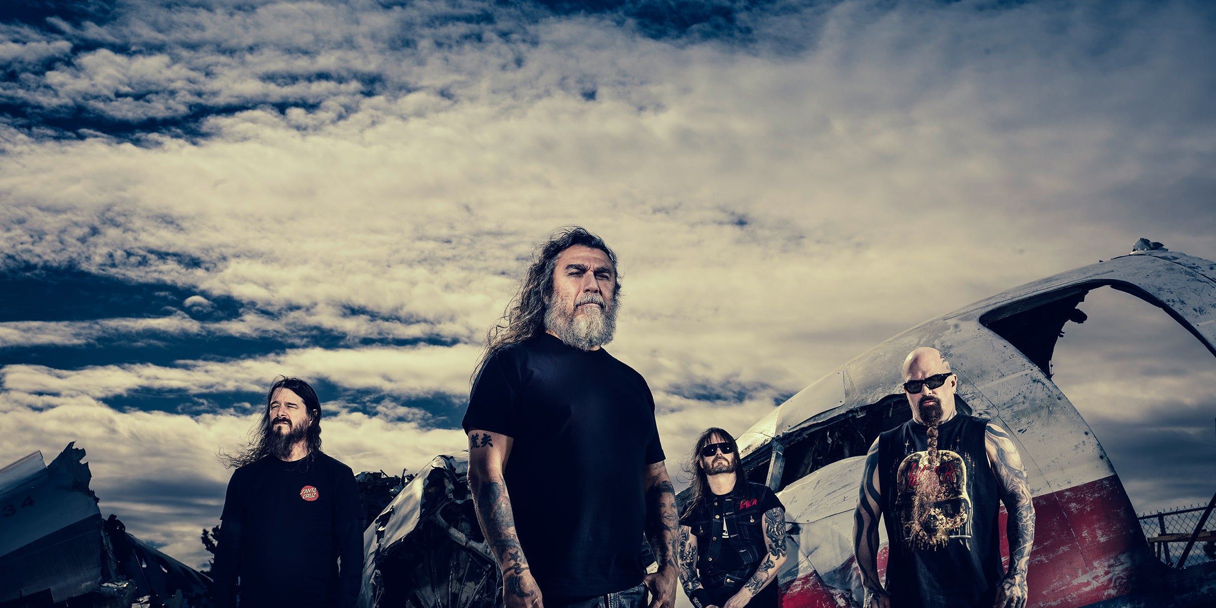 Slayer performing live on stage with dramatic lighting during their reunion era