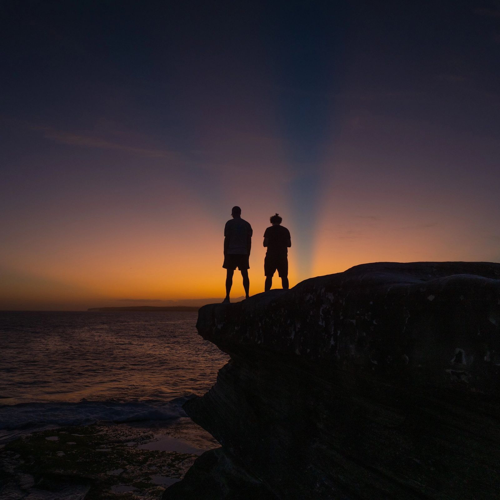 Cliff Dusk Two Figures