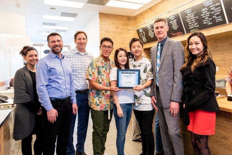 Harsch's retail team poses with restaurant owner Justin Hwang, and his wife, Jeannie