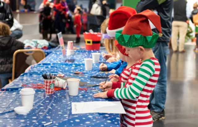 kids with crafts at gresham station merry mondays event