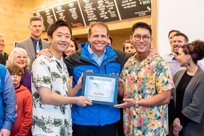 Joy Poke owner Justin, and partner Shaun, pose with the mayor of Troutdale, Casey Ryan