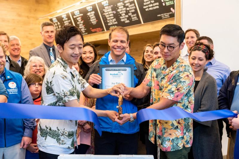 Justin Hwang and business partner Shawn, cut the ribbon