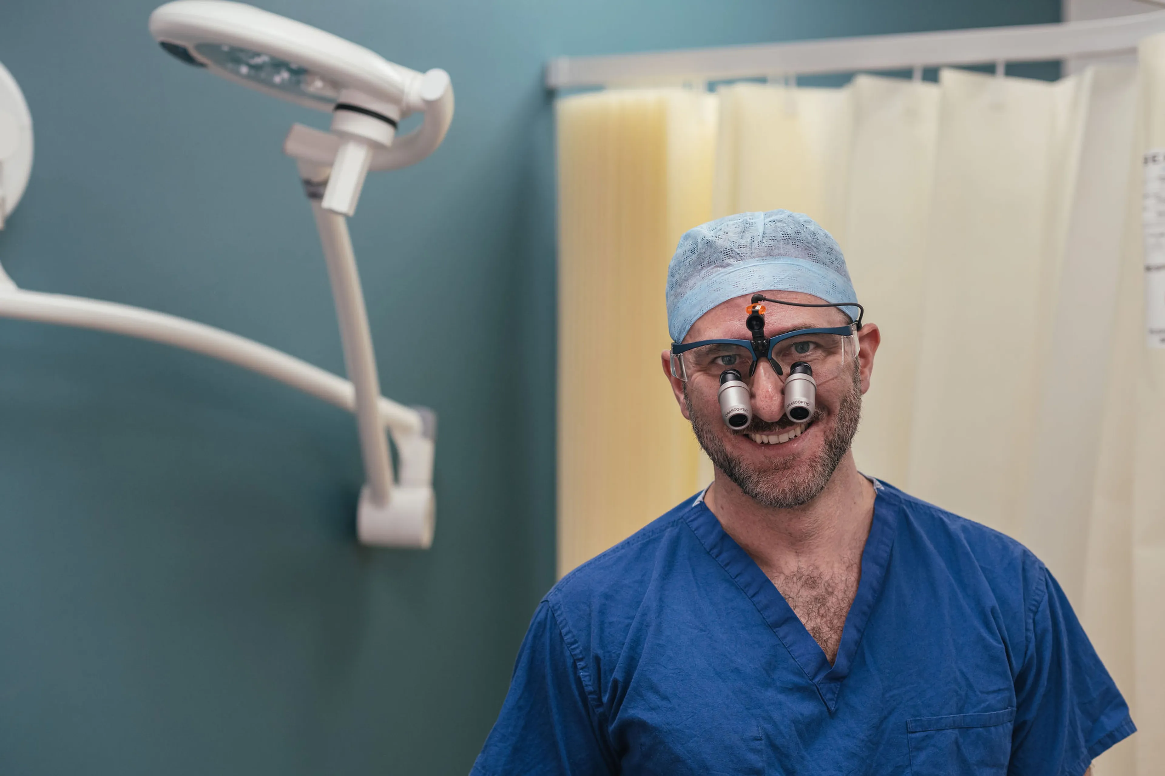 Consultant urologist using magnifying surgical loupes at a London clinic