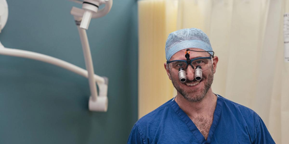 Consultant urologist using magnifying surgical loupes at a London clinic