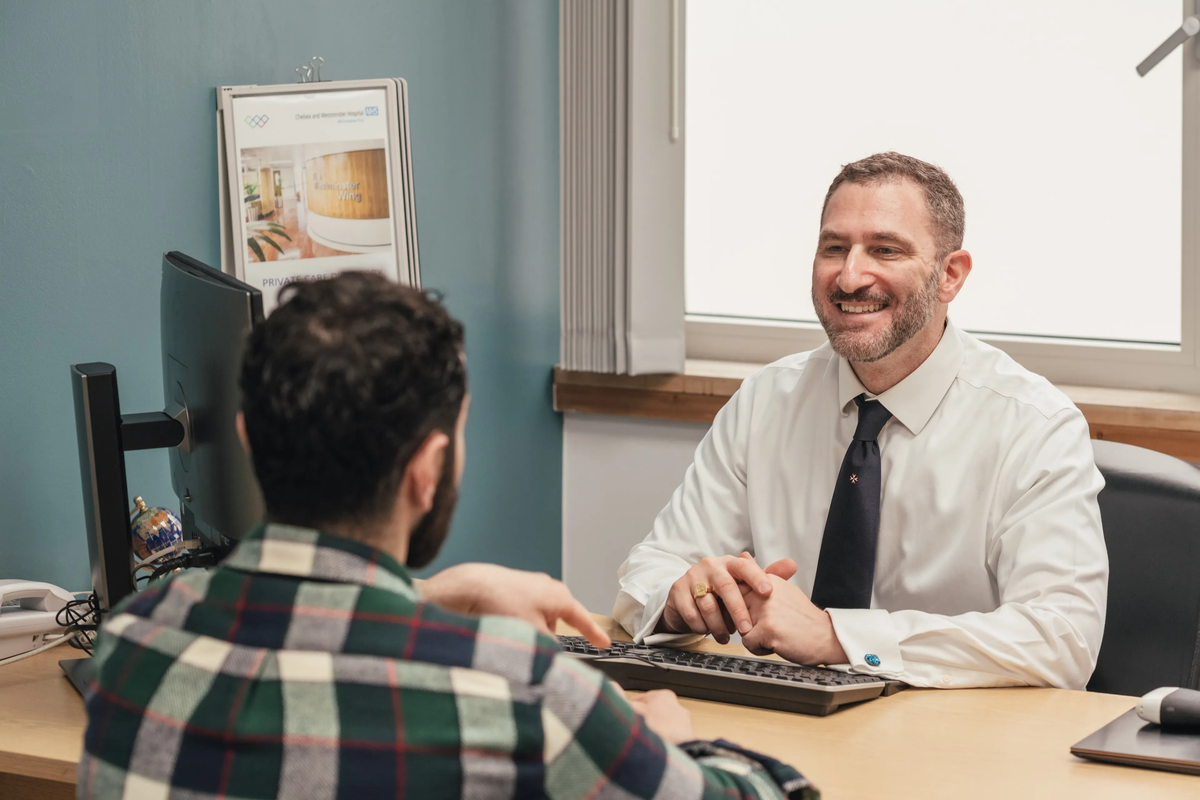Mr Ollandini explaining results to a patient during a consultation