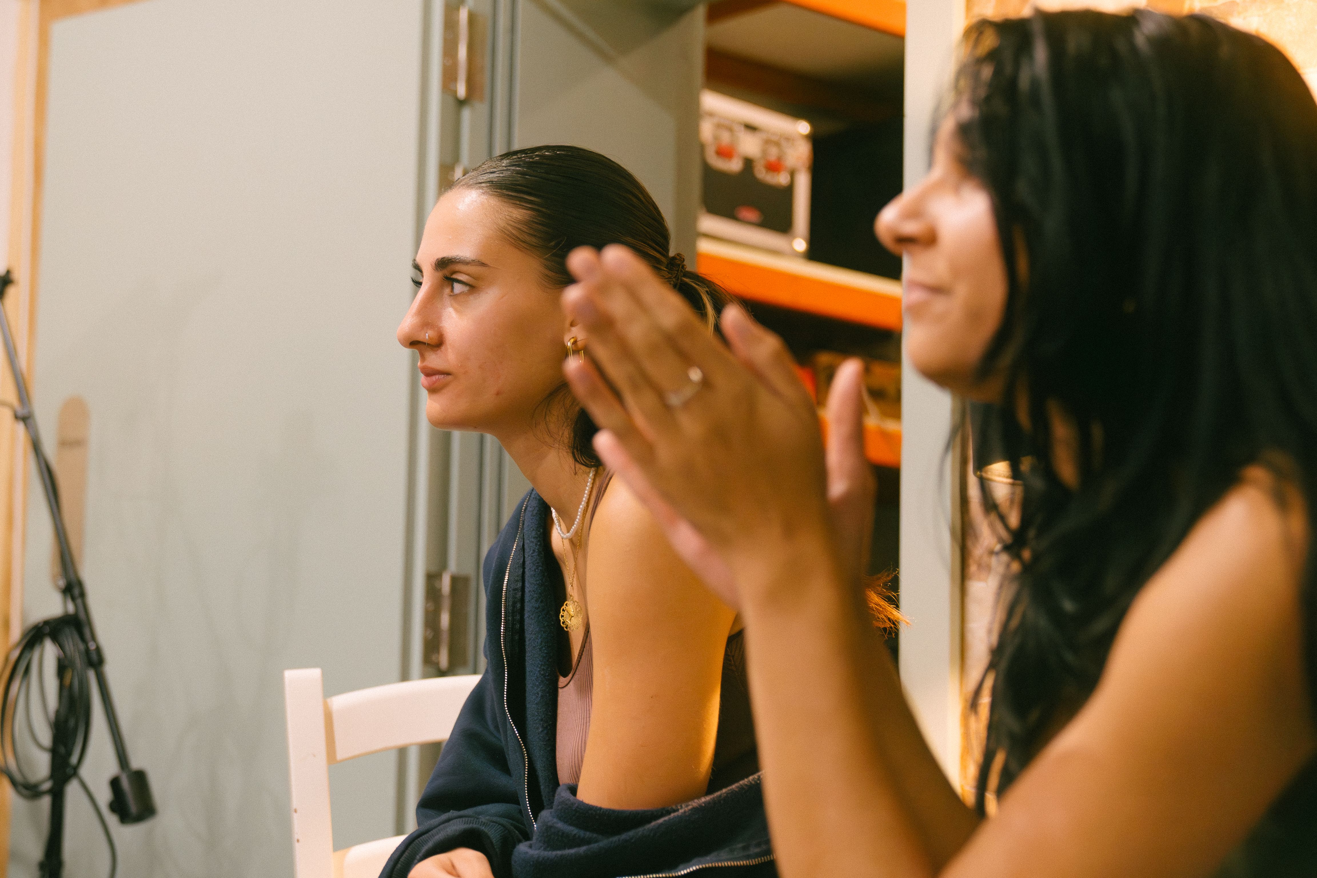 two singers clapping during their studio session