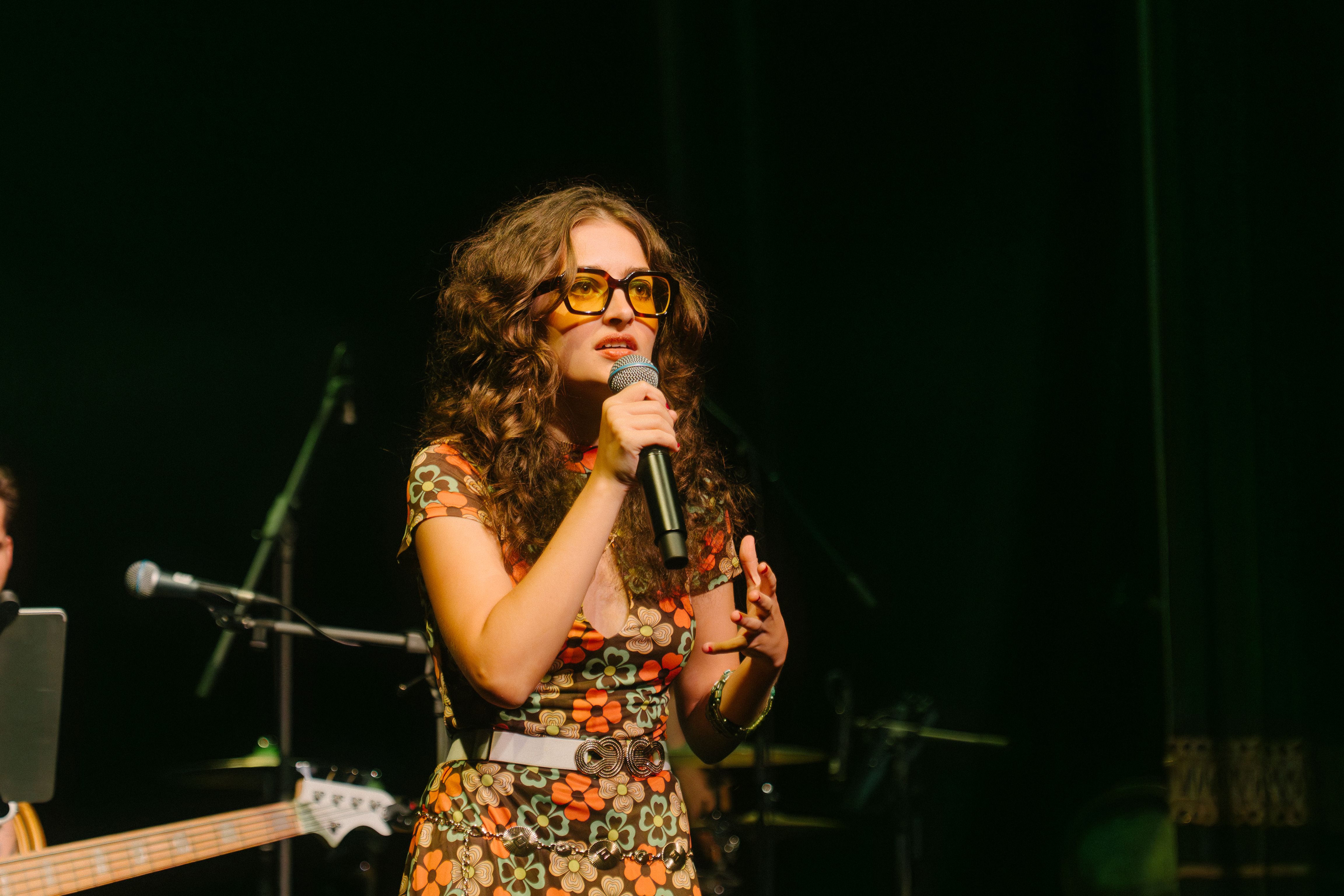 Singer in sunglasses and a colourful flower dress