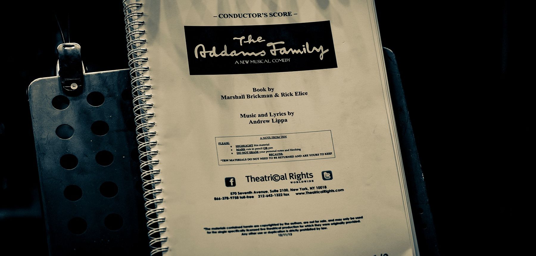 Conductor score of The Addams Family Musical on music stand