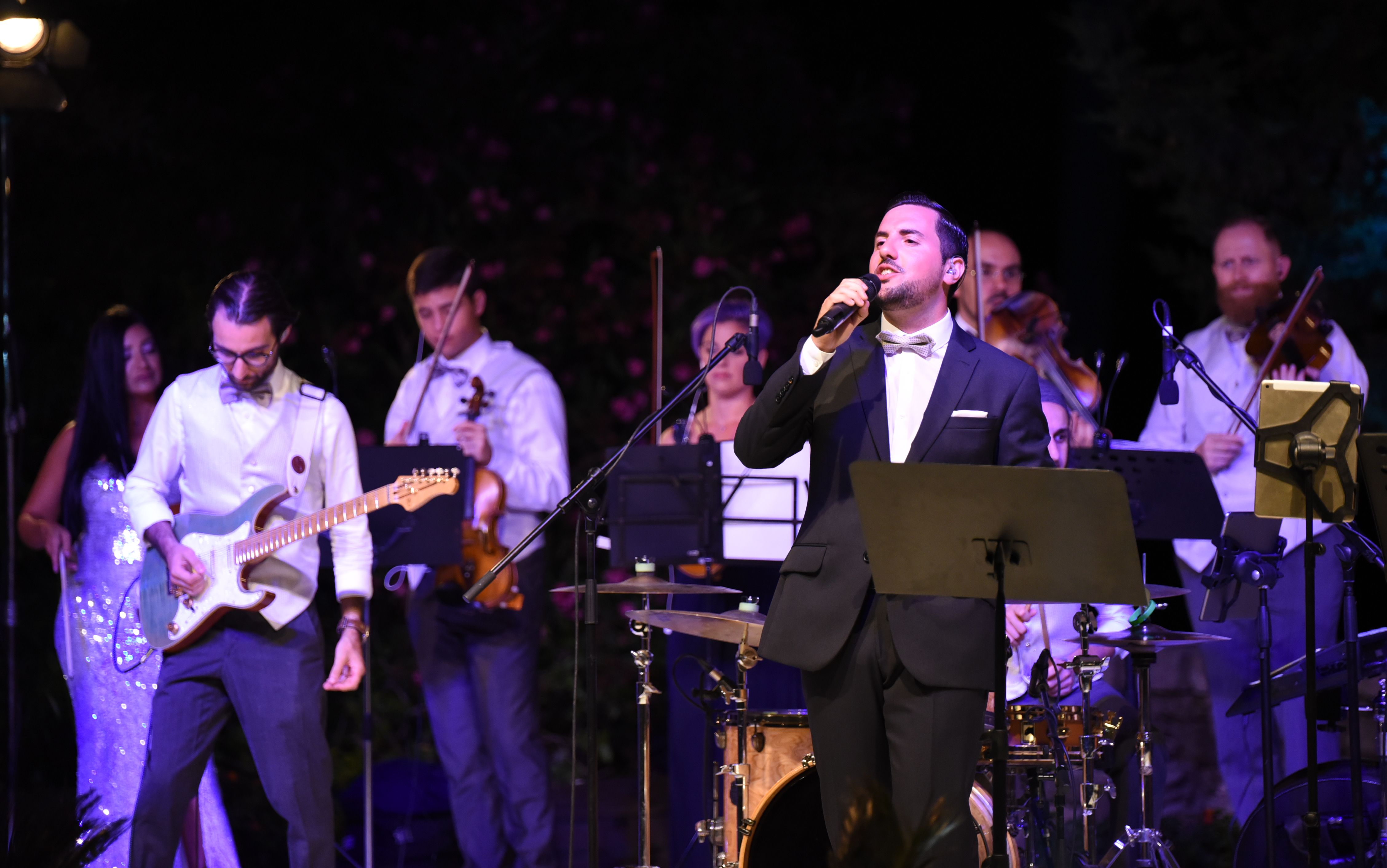 Man in Tuxedo in front of pop orchestra