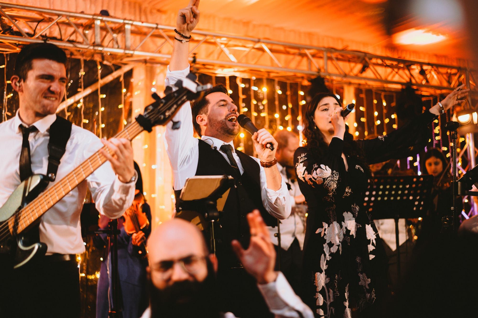 wedding crowd in front of stage packed with musicians and pop singers all having fun