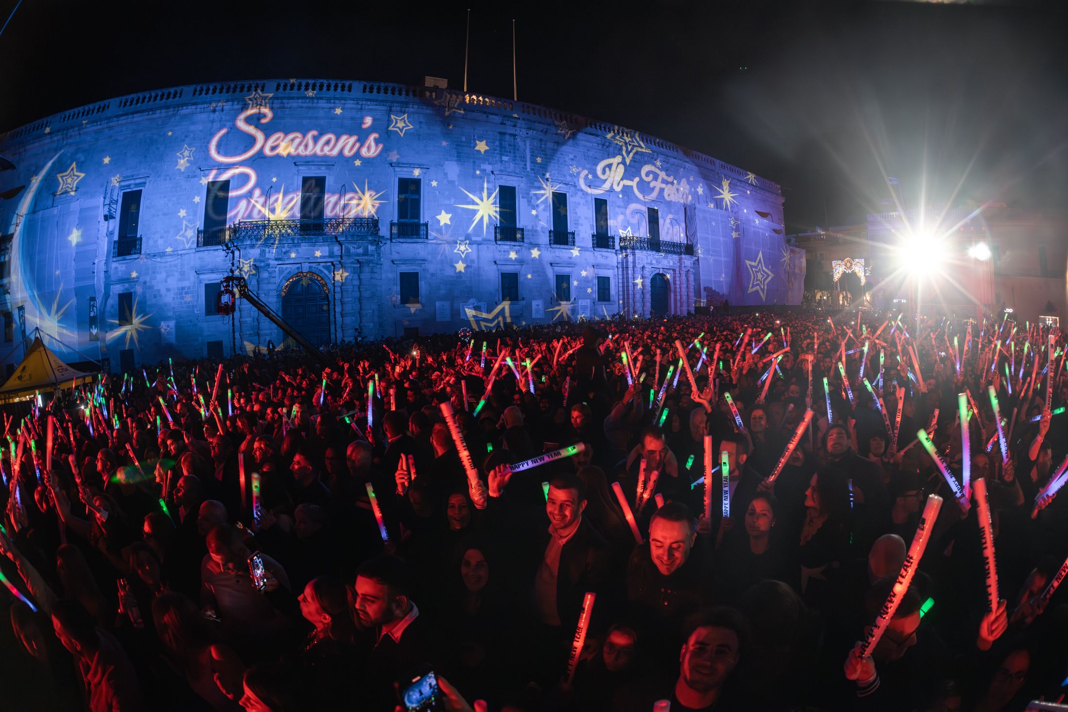 A crowd with light-up foam sticks