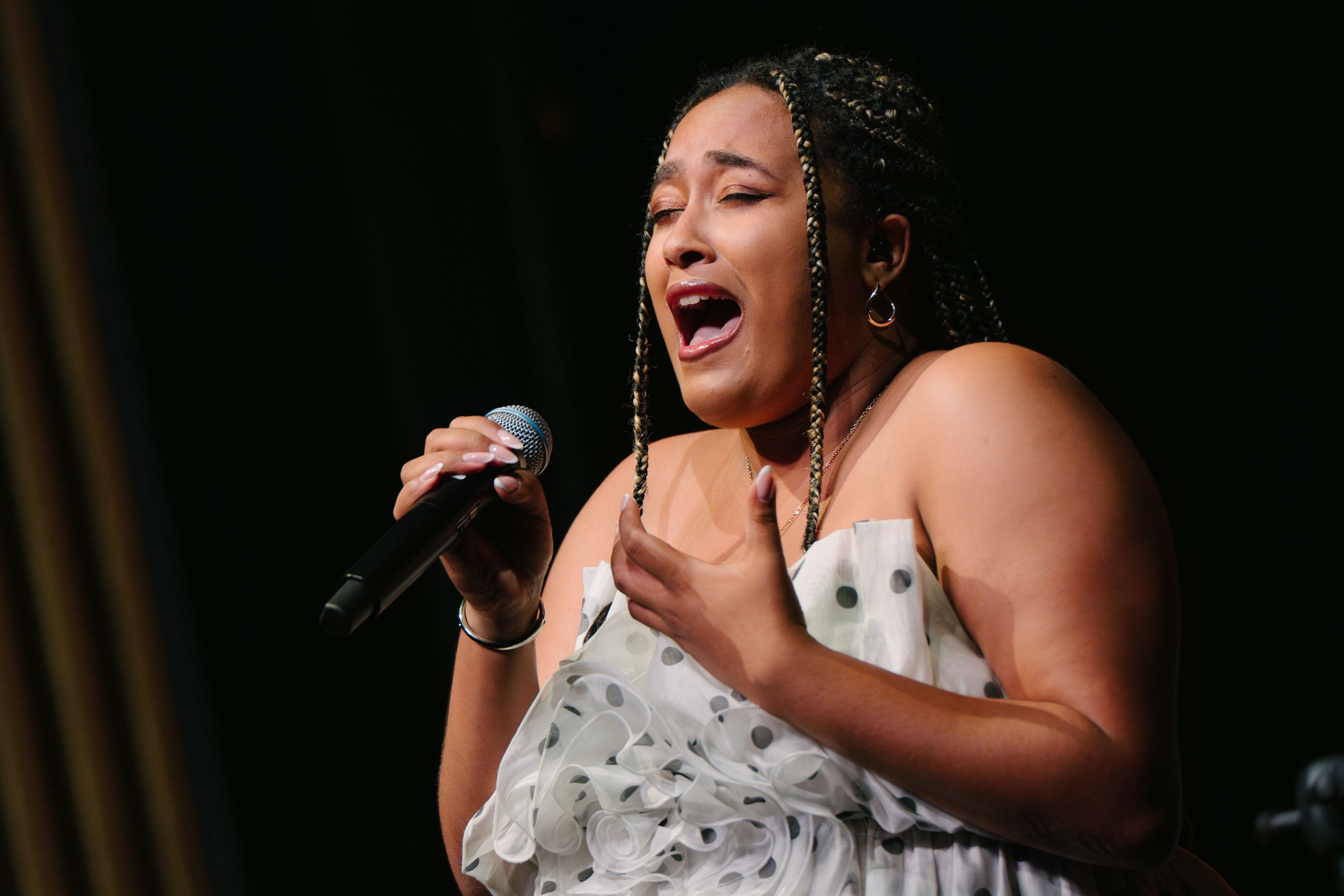 one singer singing passionately into a mic
