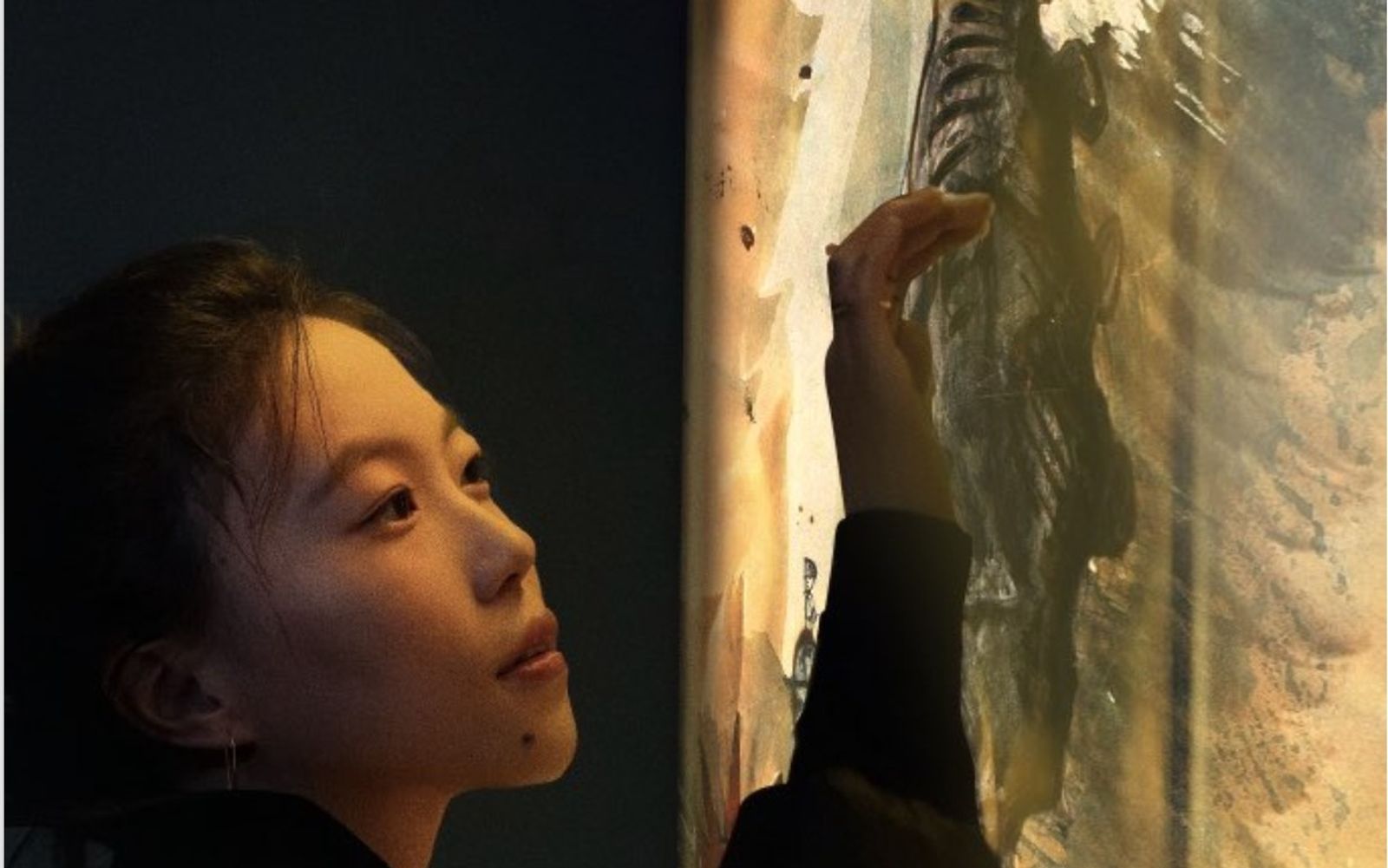 Visitor touching a projected artwork