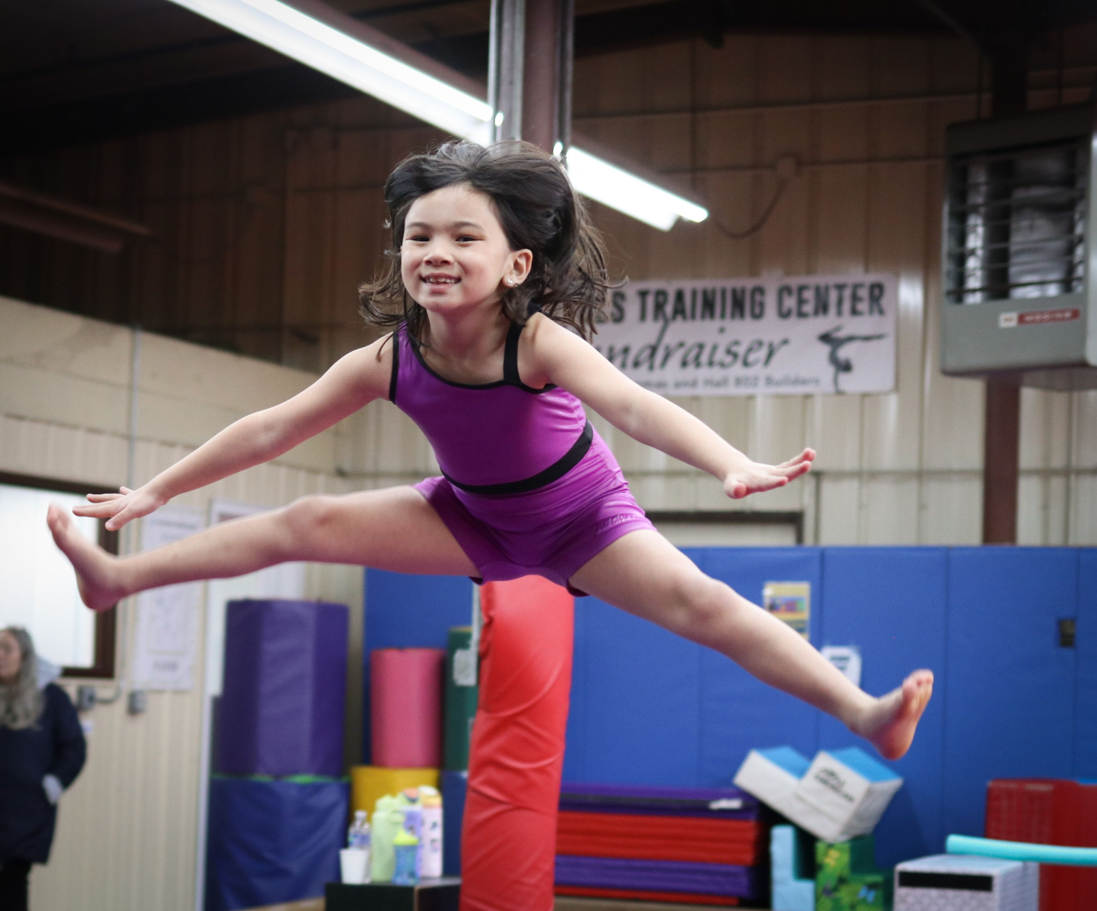 instructor and student working on bar