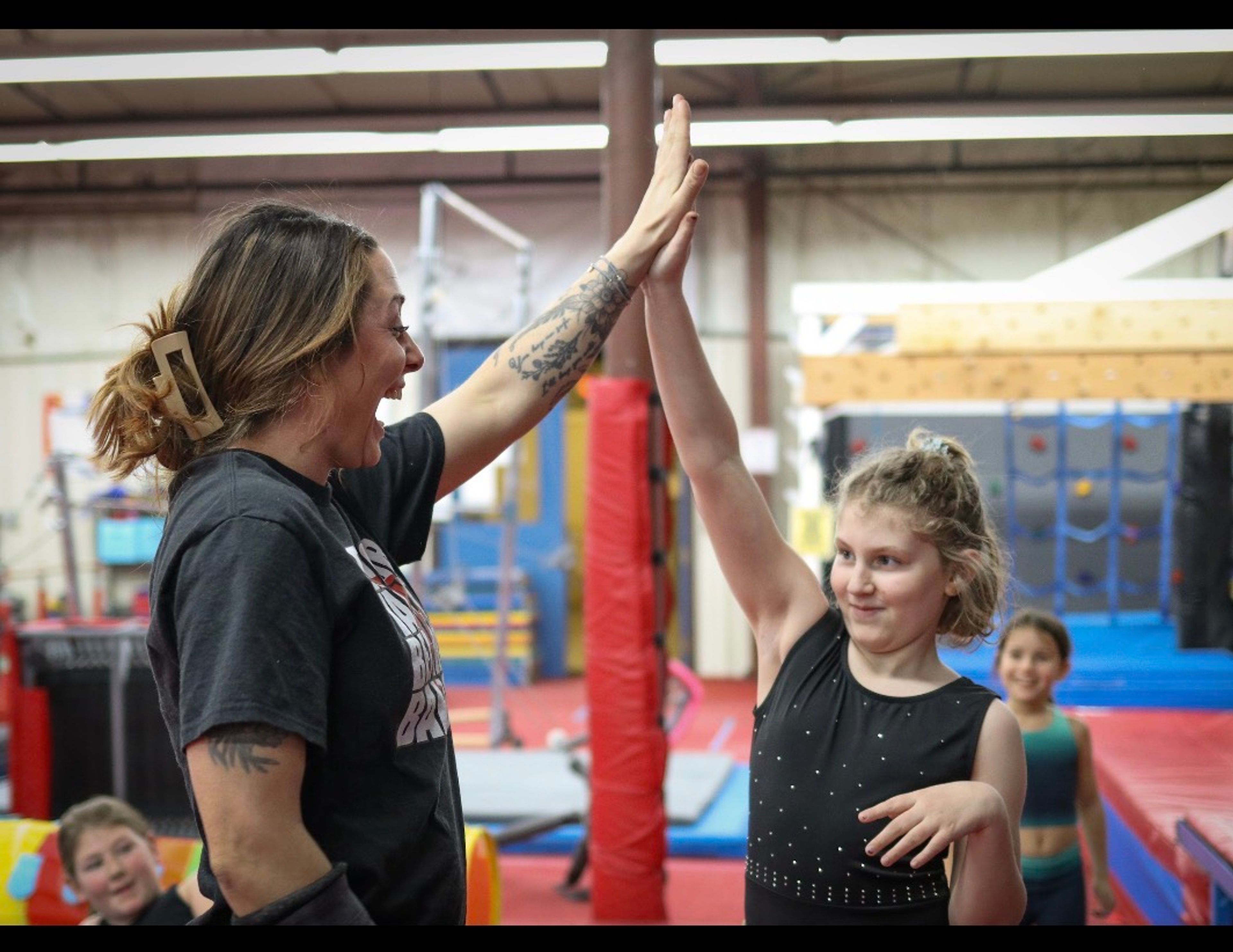 Kids in a handstand on the beam.