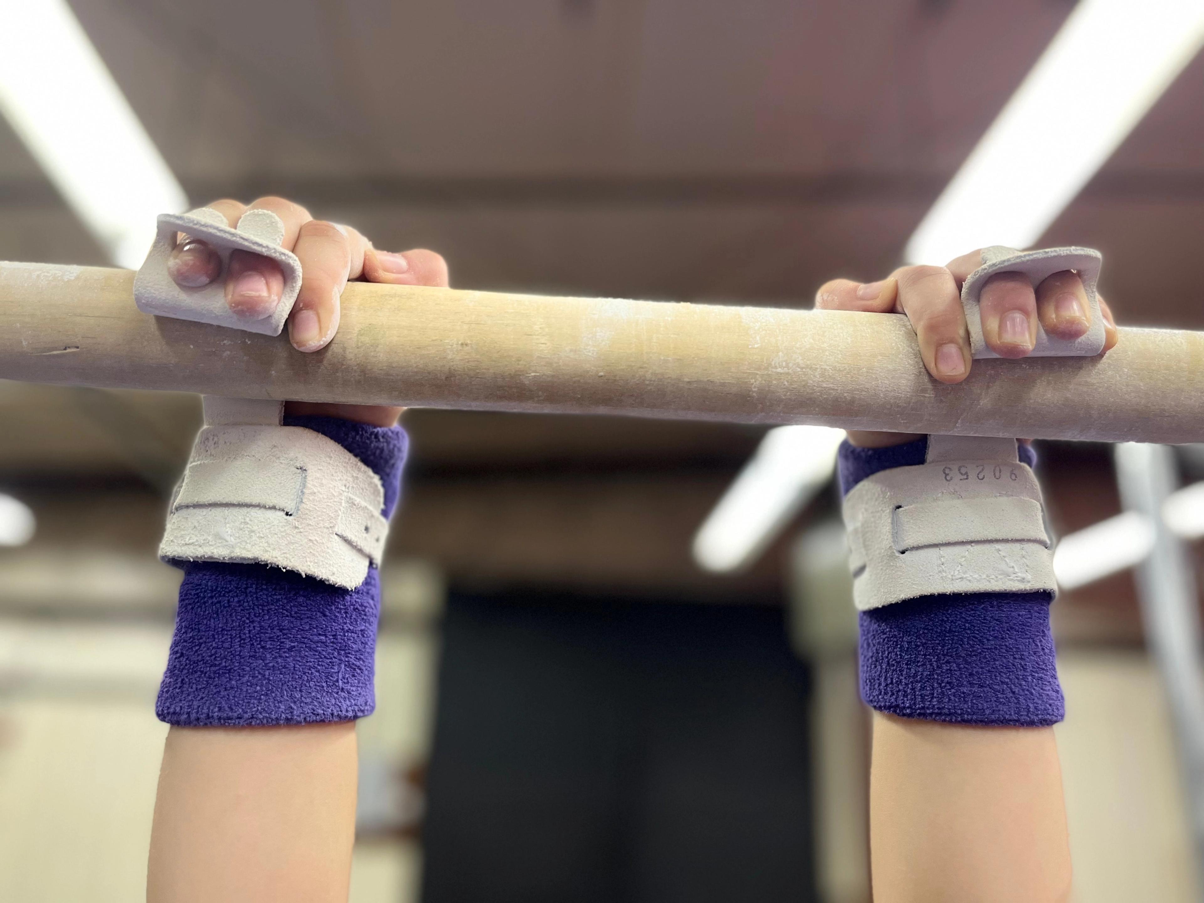 gymnast's hands on a bar