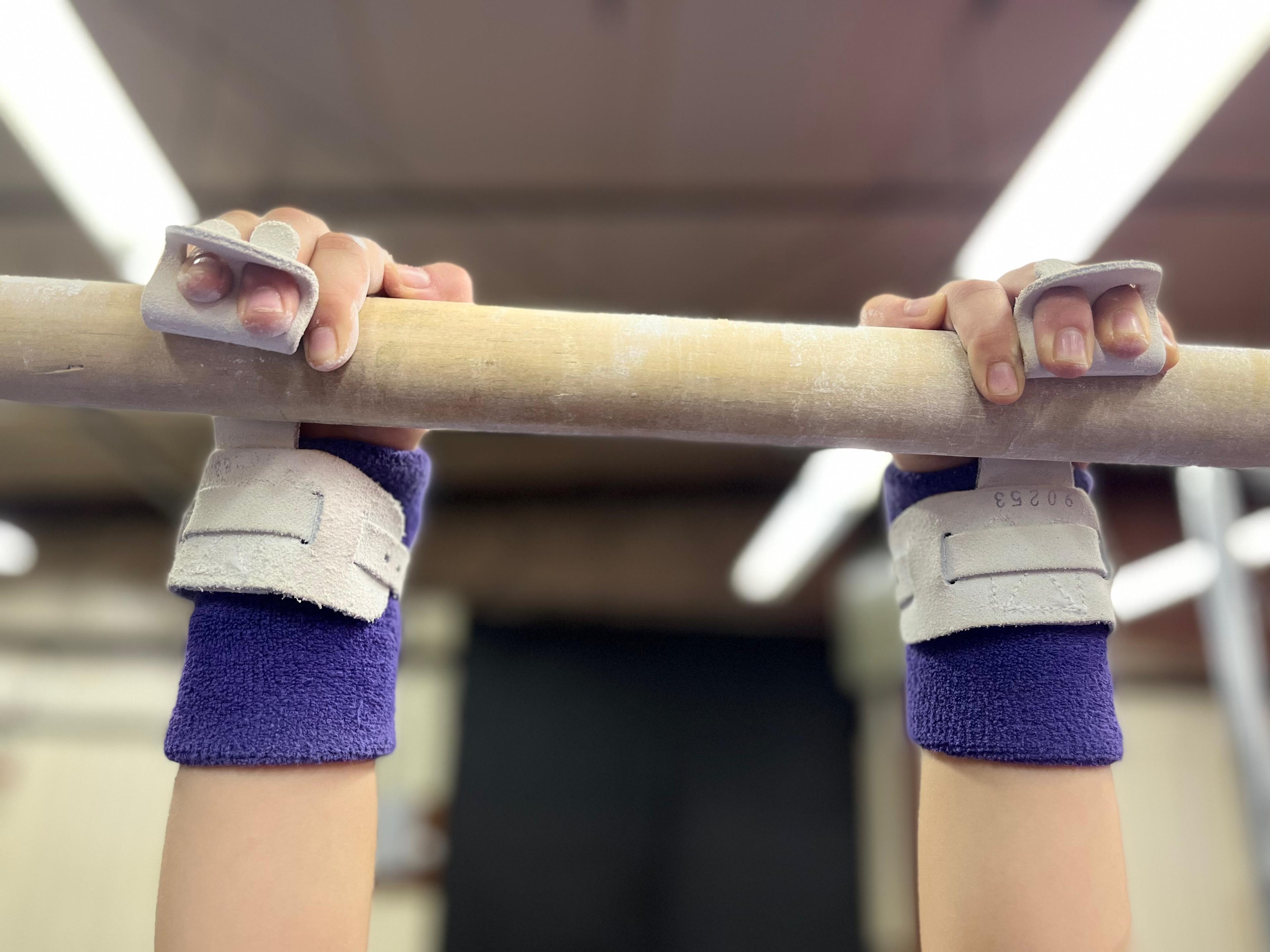 gymnast's hands on a bar
