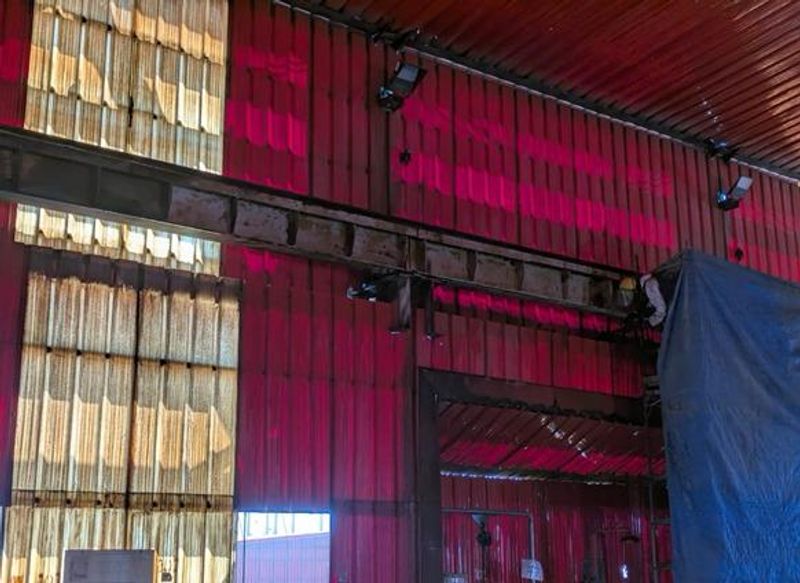 Detalle de estructura metálica con tratamiento anticorrosivo, trabajador en terreno