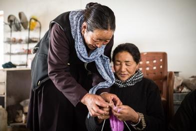 Two women knitting during a handicraft training