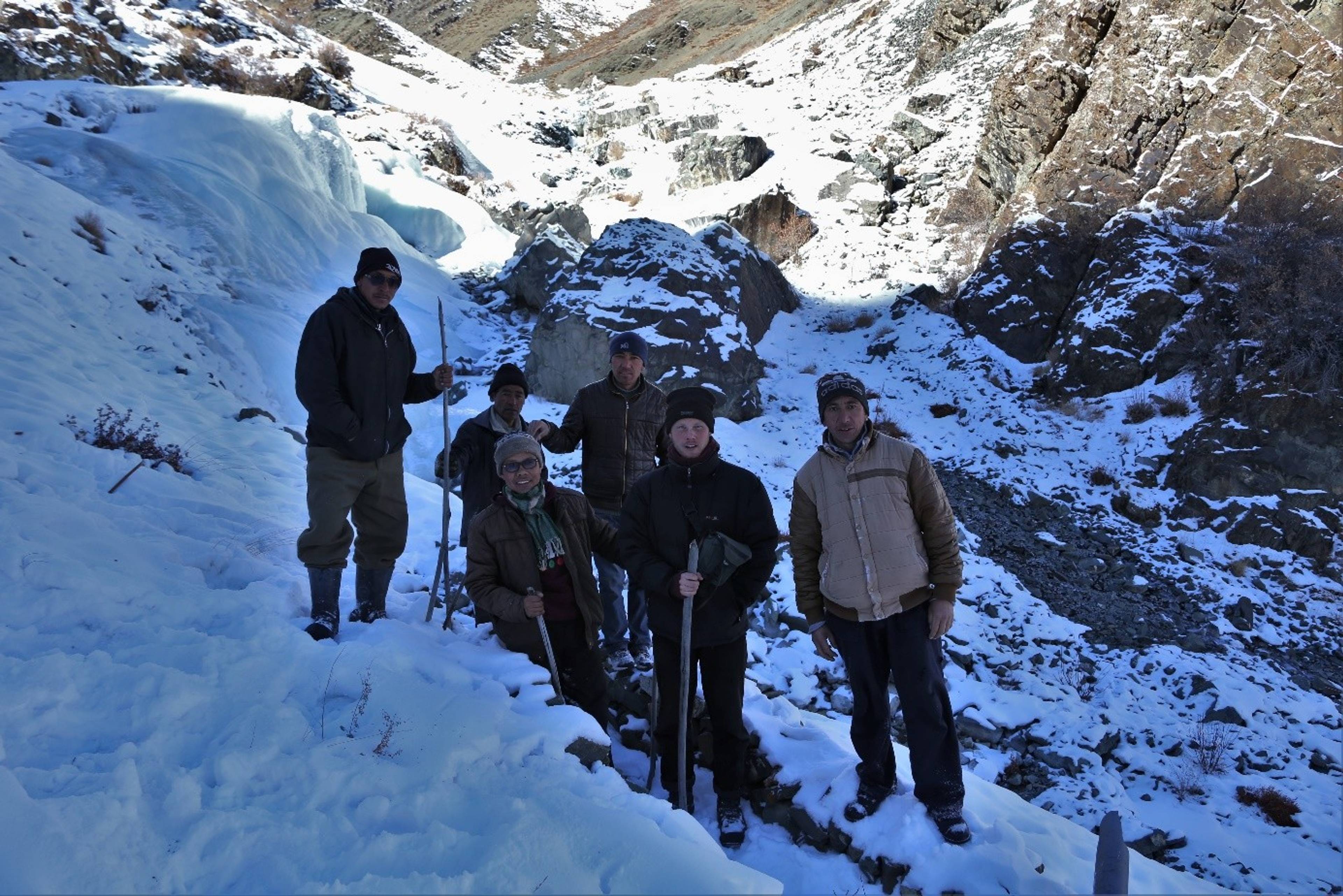 A LEHO team conducts a site survey for a new artificial glacier location in the mountains near Leh.