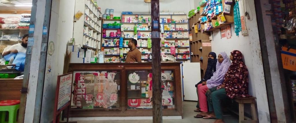 shot of pharmacy with three woman waiting