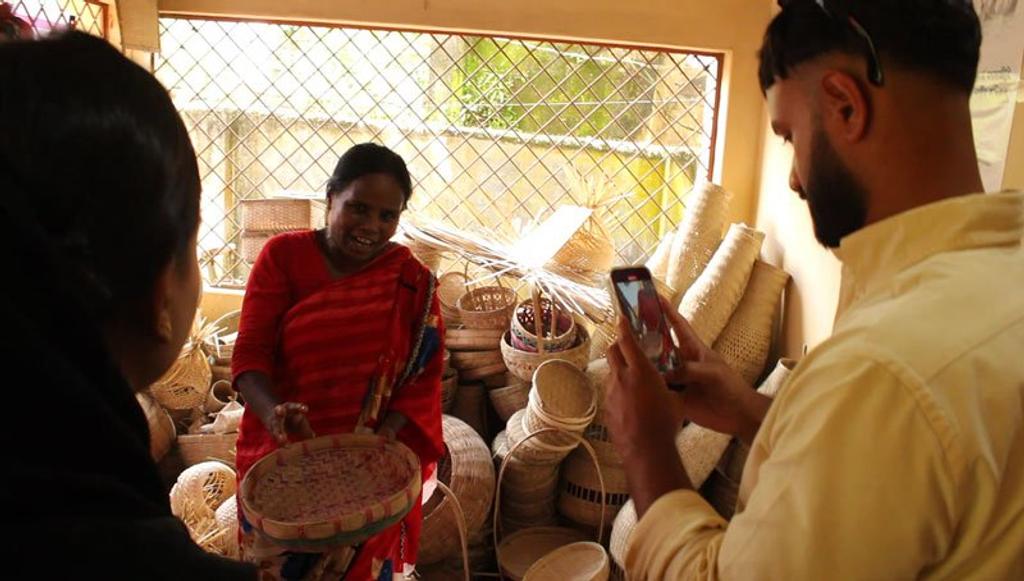 woman showing her bamboo products whilst being recorded