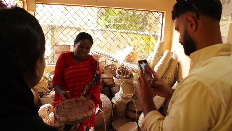 woman showing her bamboo products whilst being recorded