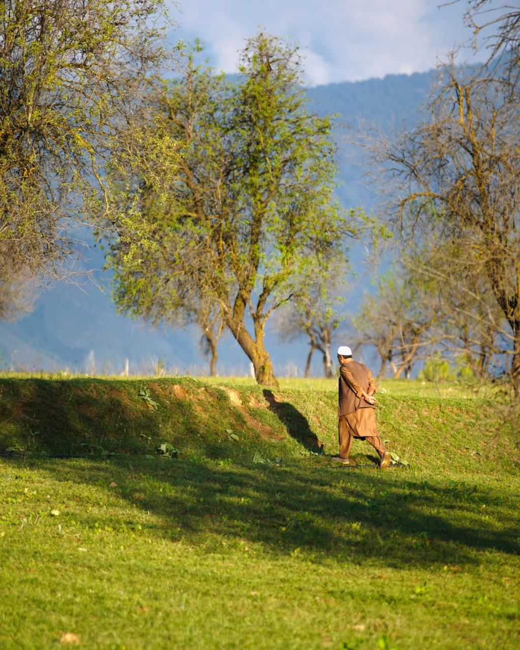 man walking in Pakistan field