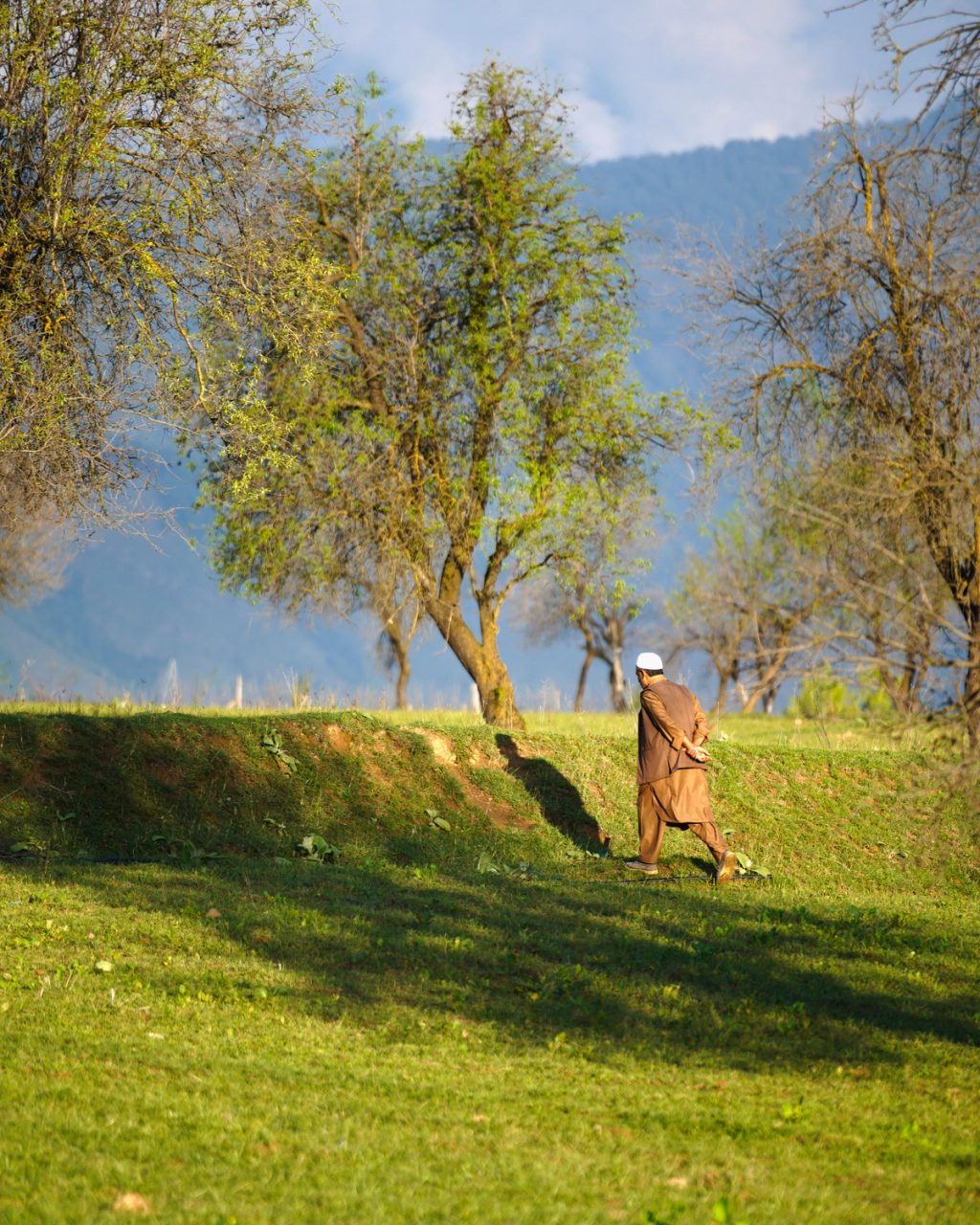 man walking in Pakistan field