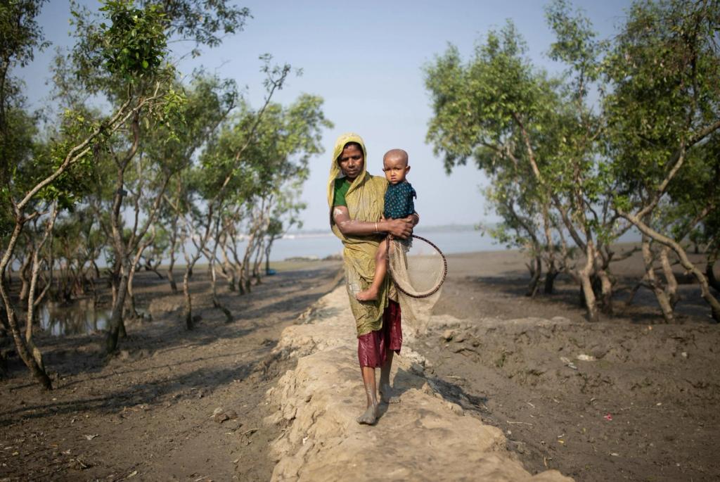 woman walking with child in hand