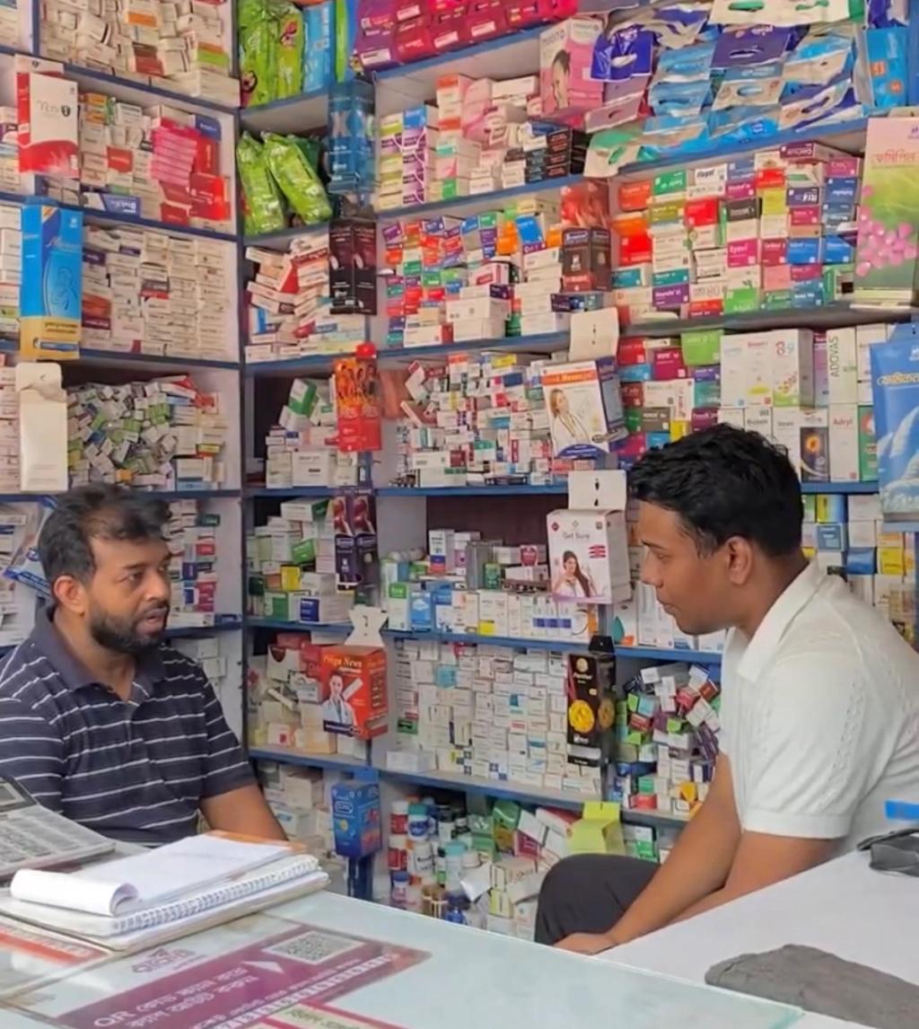 man sitting inside his pharmacy