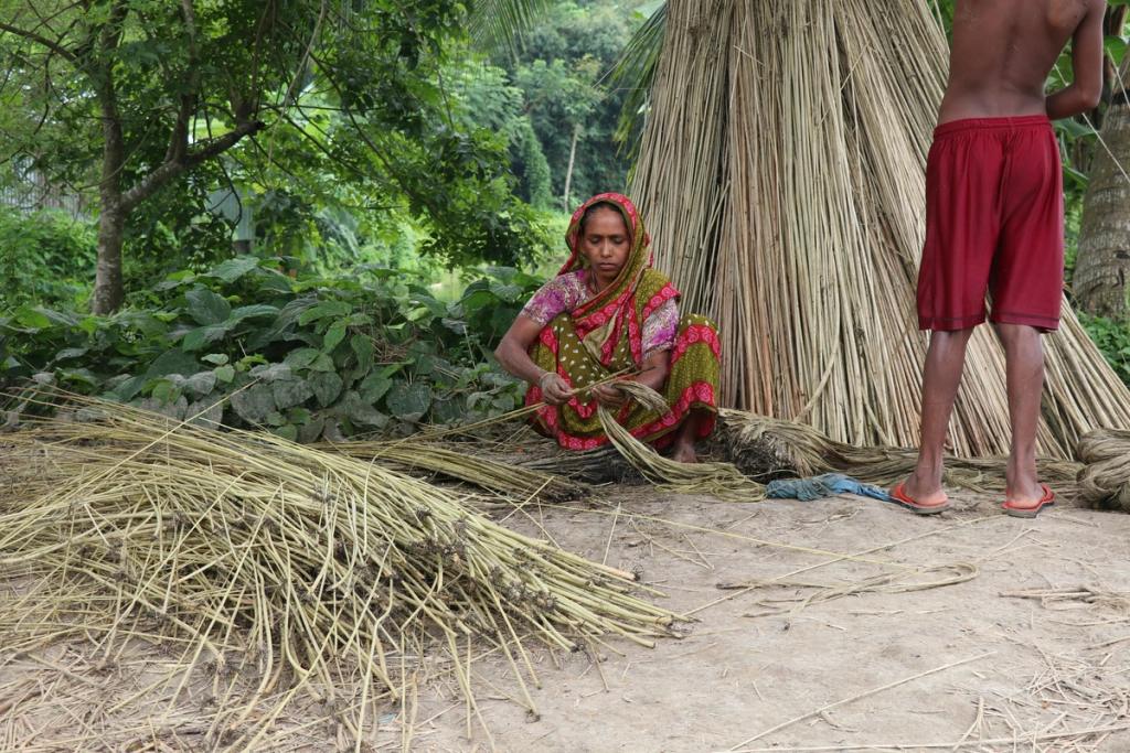 woman trimming bamboo in Bangaldesh
