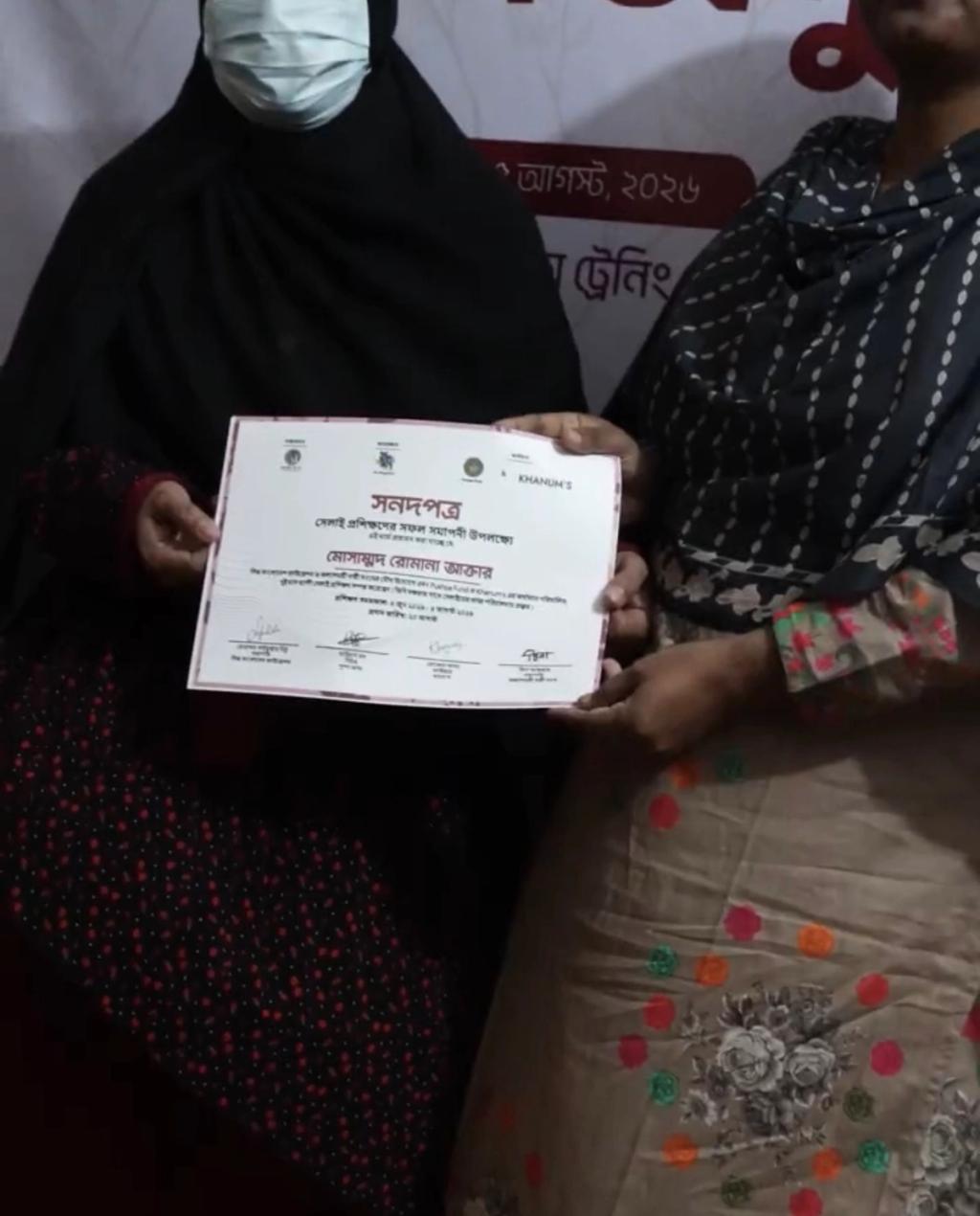 woman holding graduation certificate