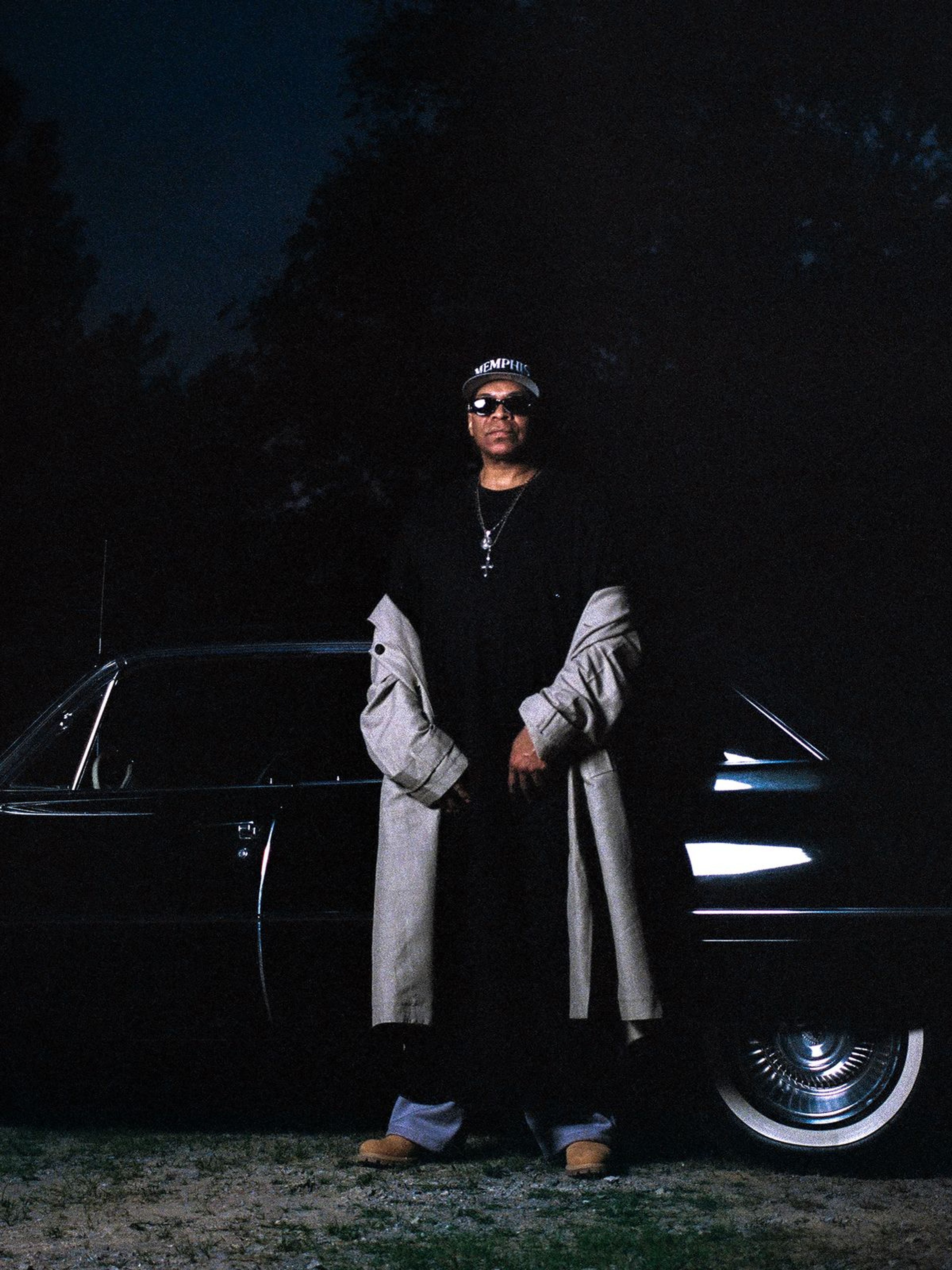 DJ Spanish Fly in front of a car