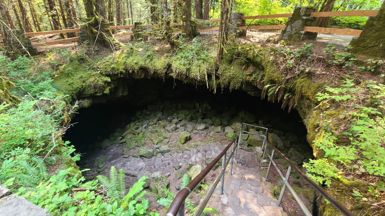 A path leads down into the entrance of a cave