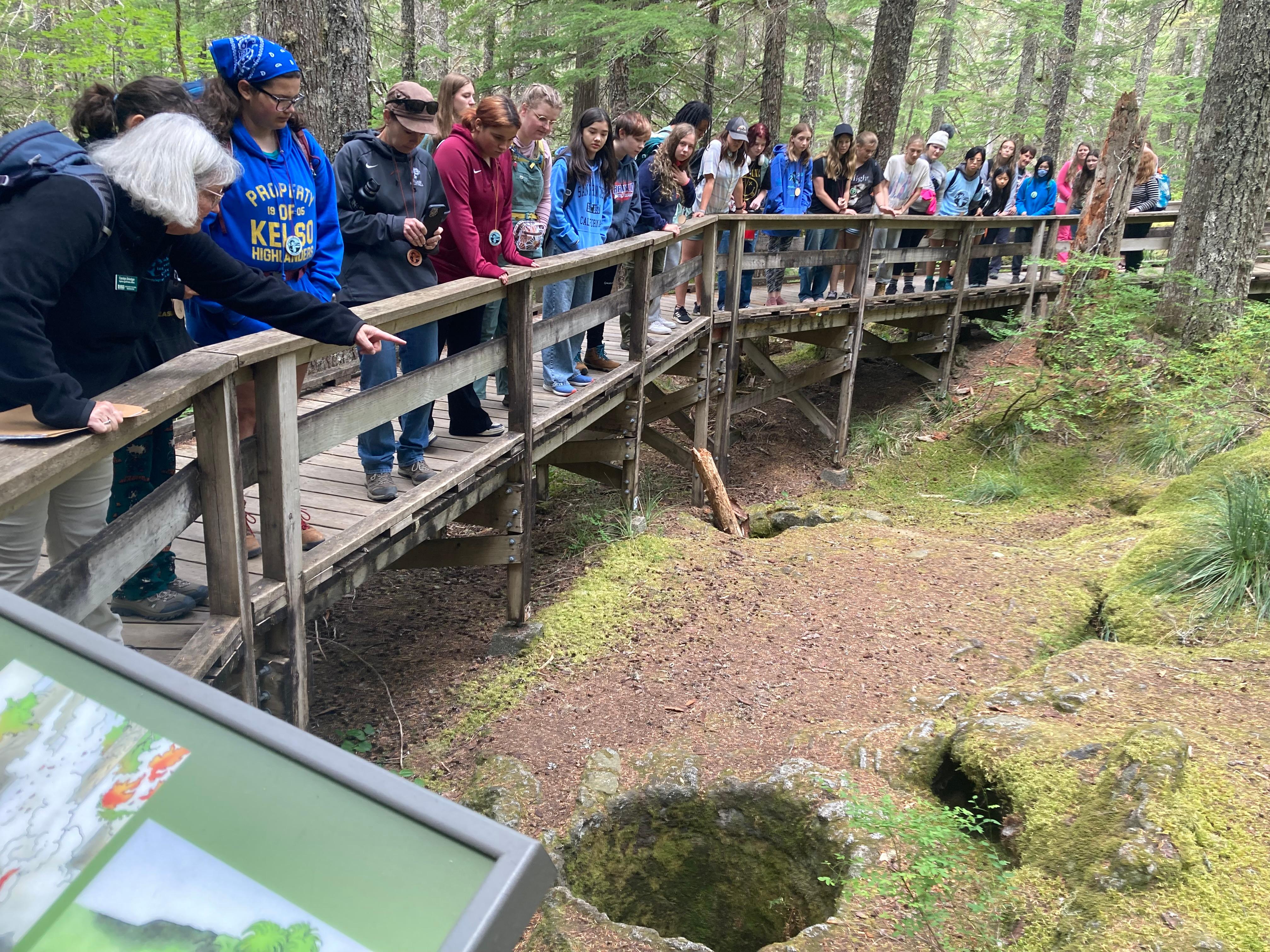 Field trip to the Trail of Two Forests. People looking at a tree cast in a 2000 year old lava flow.