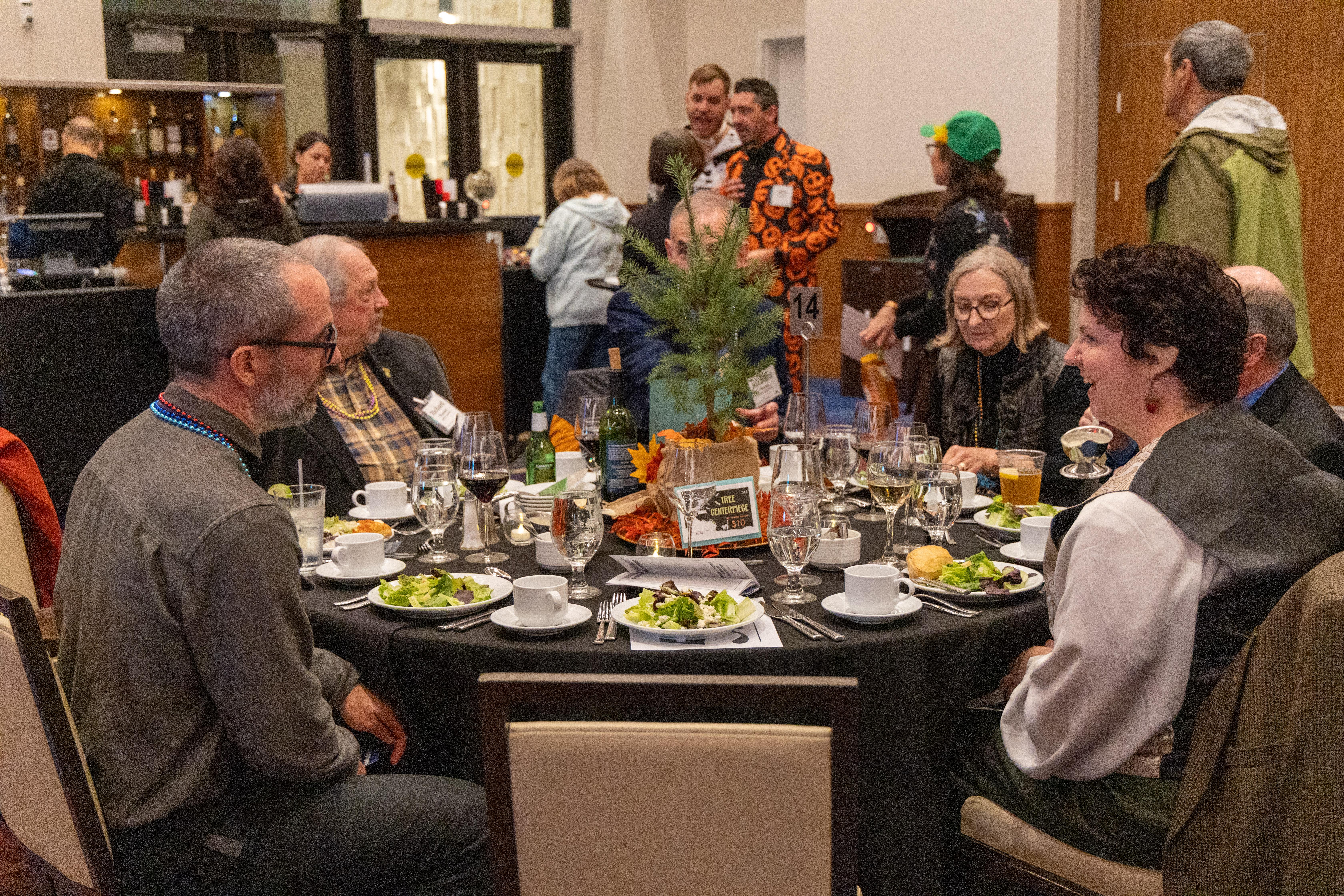 Attendees visit together at Boots and Bow Ties after volunteering to help set up the event
