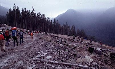 Hikers trek across the edge of the blast zone of Mount St. Helens in 1982.