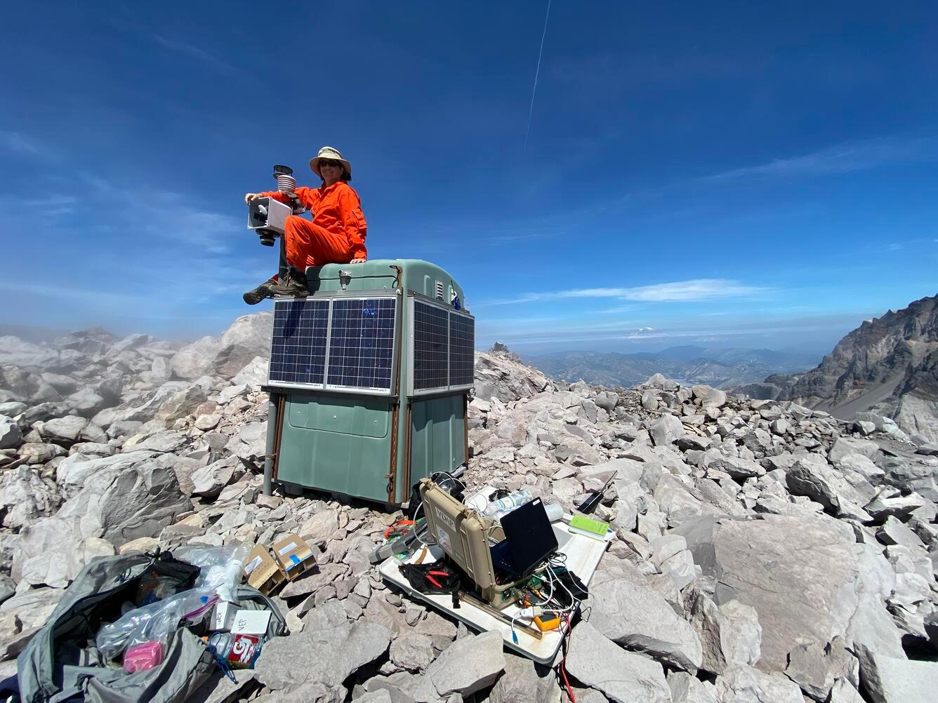 USGS scientist Laura Clor performing maintenance on the SNIF multi-GAS station on Mount St. Helens, Washington.