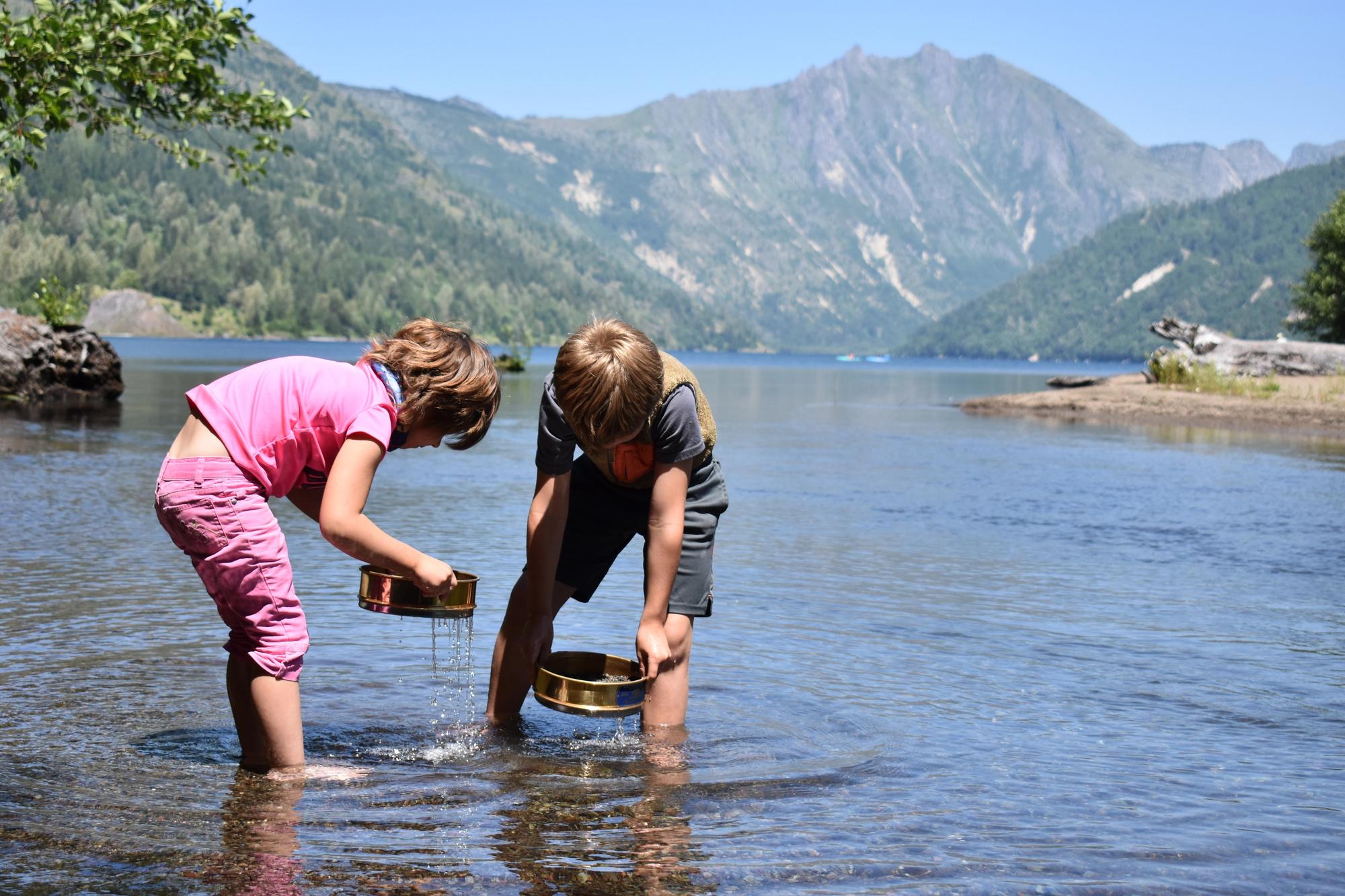 children participating in a hands on science project at Mount St. Helens during a private family adventure