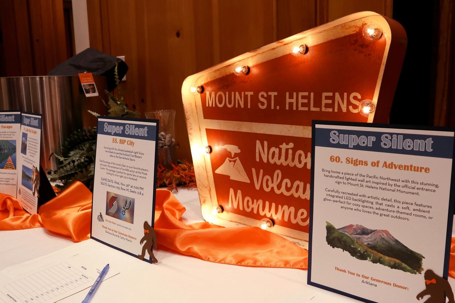 A national parks-style sign on display in the silent auction at Boots and Bow Ties
