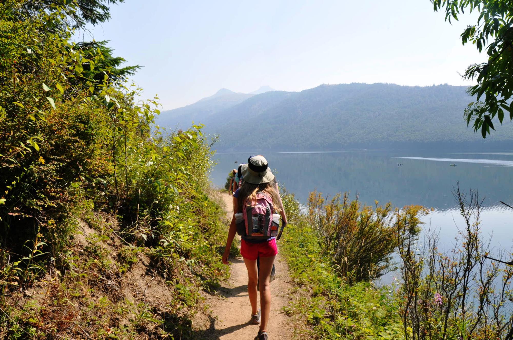 People hiking on a trail at Coldwater Lake near Mount St. Helens