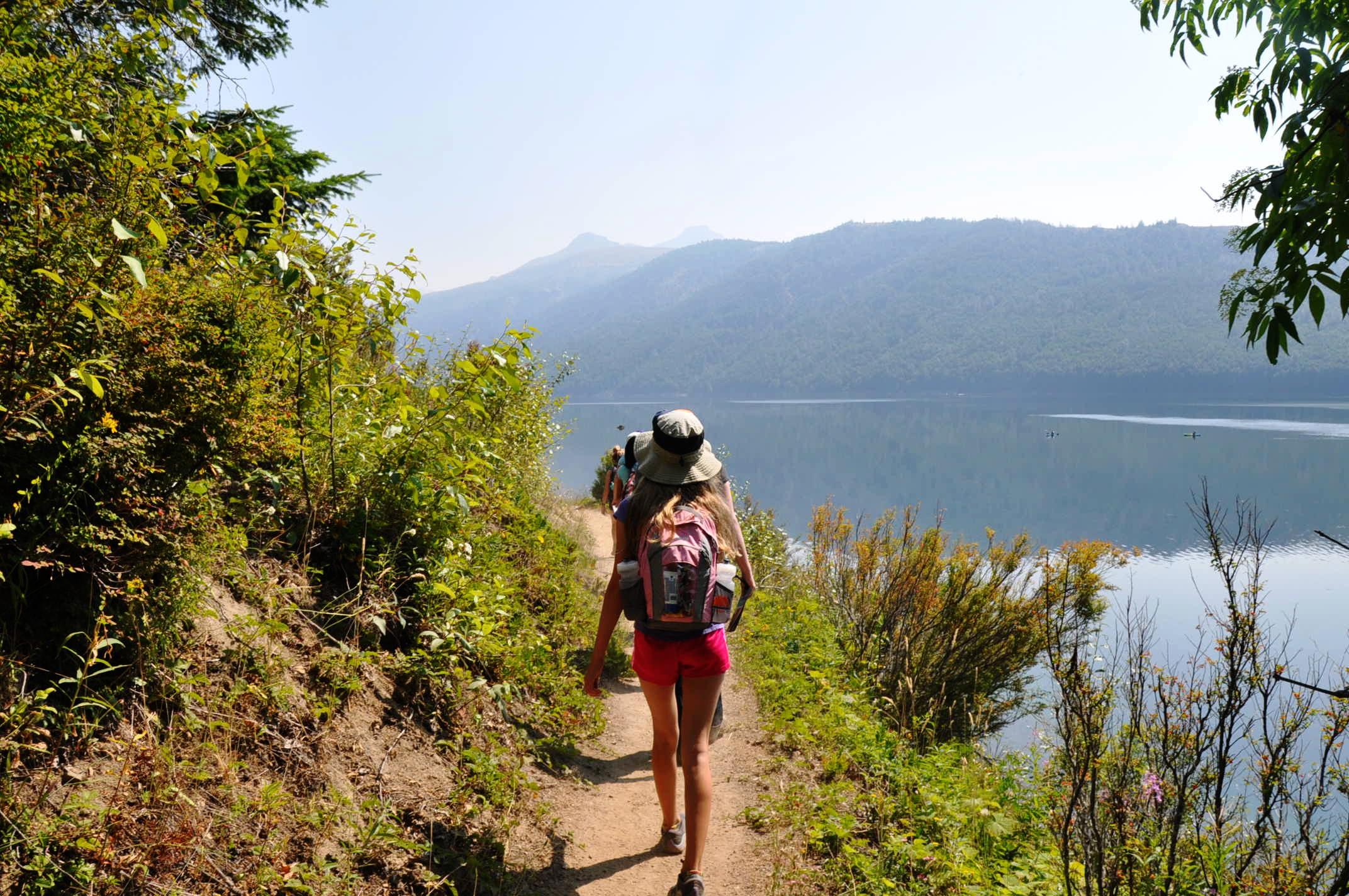 People hiking on a trail at Coldwater Lake near Mount St. Helens