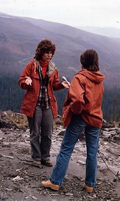 With a backdrop of the blast zone, Susan Saul gives a TV interview in 1981.