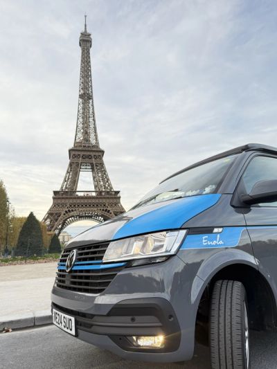 Enola parked in front of the Eiffel Tower in Paris