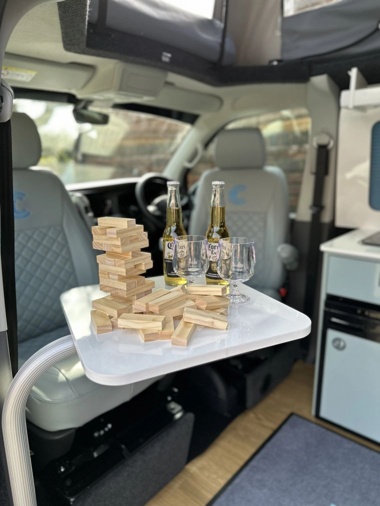 A game of Jenga and two bottles of beer on the table in Enola, by the swivel cab seats