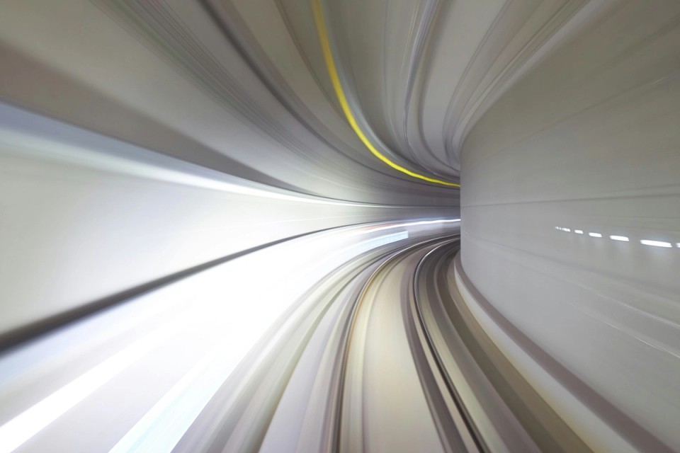 Abstract motion-blur a curved tunnel with sweeping light trails, symbolizing the interconnected, dynamic, and ever-changing nature of human movement, adaptation, and athletic development.