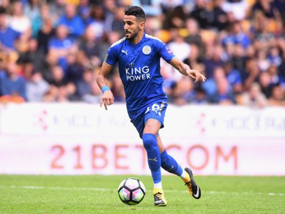 Professional footballer Riyad Mahrez carrying the ball during a match, representing the natural movement, coordination, and athletic qualities explored in this article.